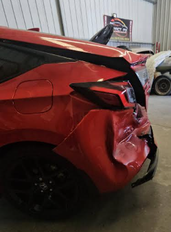 Red car rear corner collision damage before repair